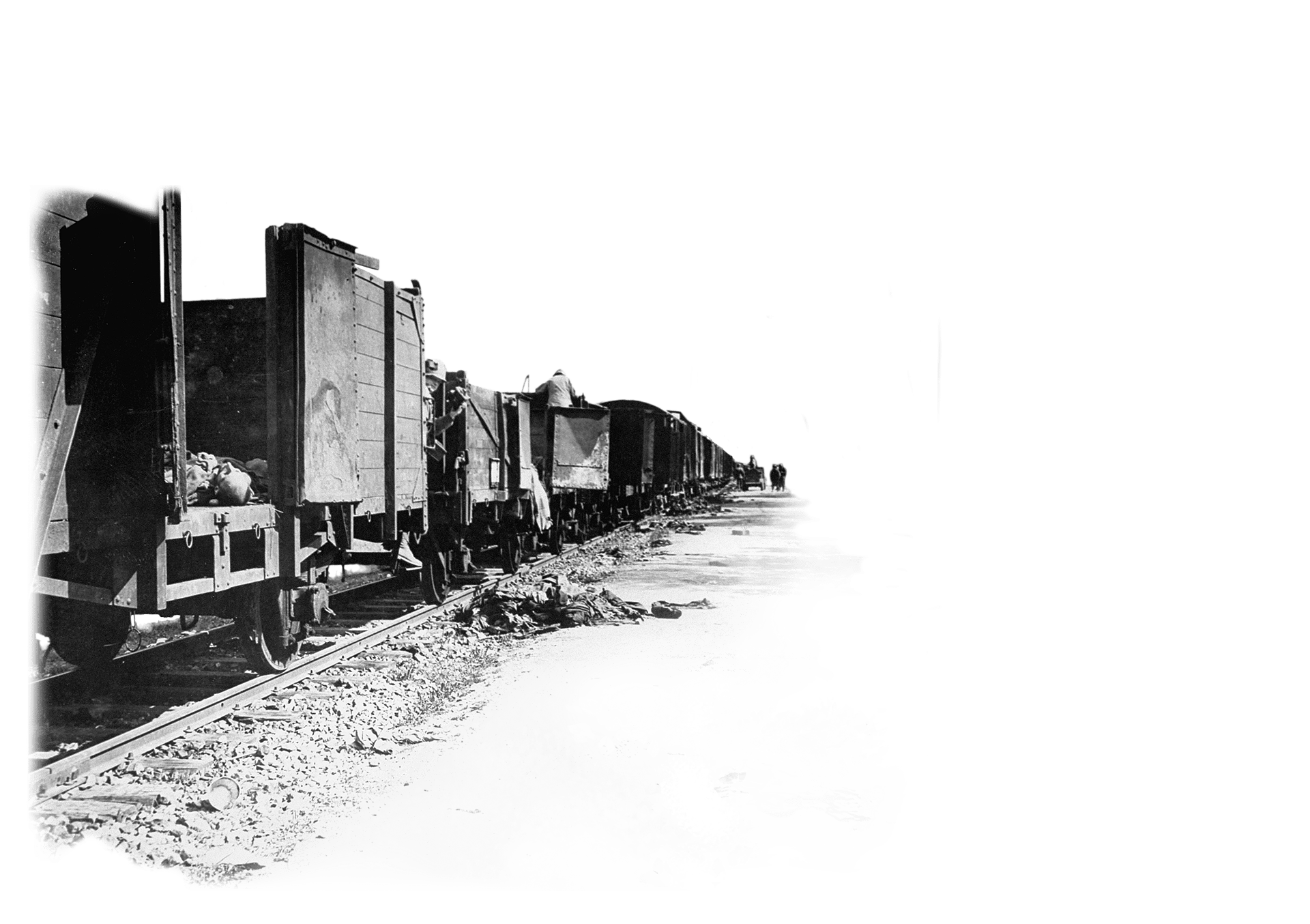 Leichen liegen in und vor einem offenen Güterzug. US Soldaten schauen in die Waggons (Foto: USHMM)